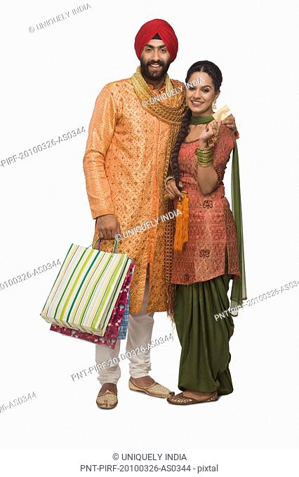 Sikh couple holding shopping bags