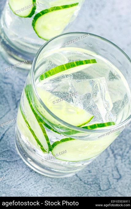 Fresh cool cucumber infused water, cocktail, detox drink, lemonade in a glass. Health care, fitness, healthy nutrition diet concept