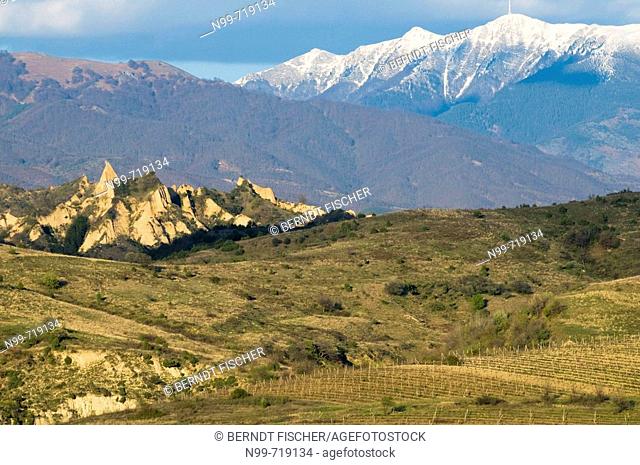 Mountains in South Bulgaria, hoodoo rocks of Melnik and snow-covered peak of Pirin mountains, cultivated landscape with vineyards,  Bulgaria