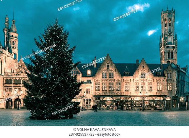 Scenic cityscape with the picturesque night medieval Christmas Burg Square in Bruges, Belgium. Toning in cool tones