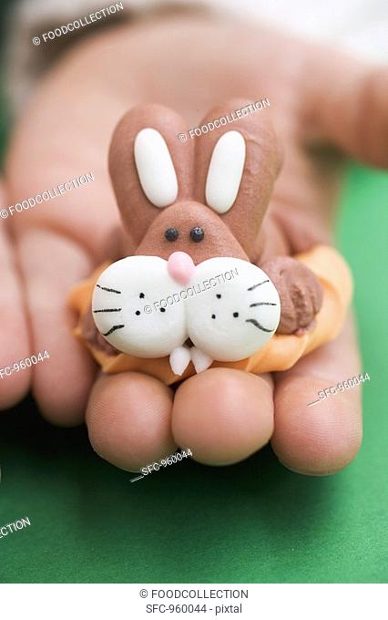 Child's hand holding marzipan Easter Bunny