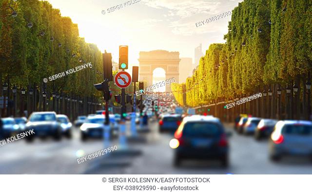 Traffic on Champs Elysee and view of Arc de Triomphe in Paris, France