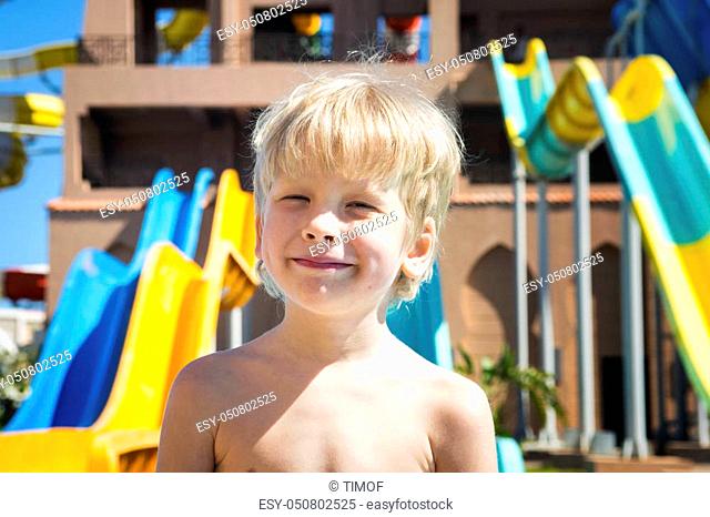 Portrait of the smiling boy against the background of aquapark