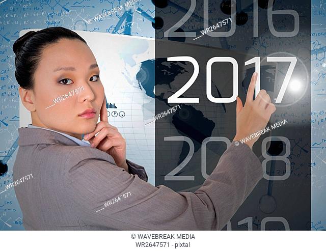 Thoughtful business woman touching 2017 in 3D digitally generated background