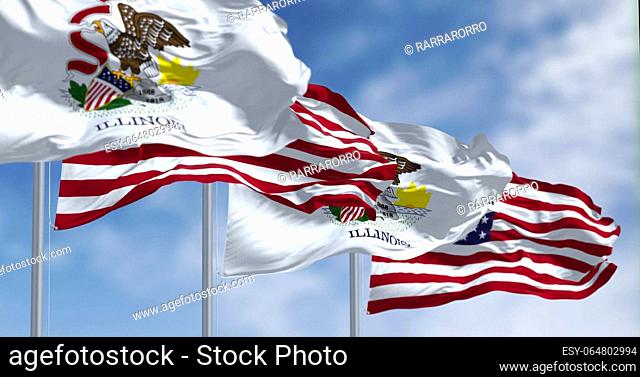 Illinois state flags waving with the national flag of the American flags on a clear day. US state flag. Pride and patriotism concept