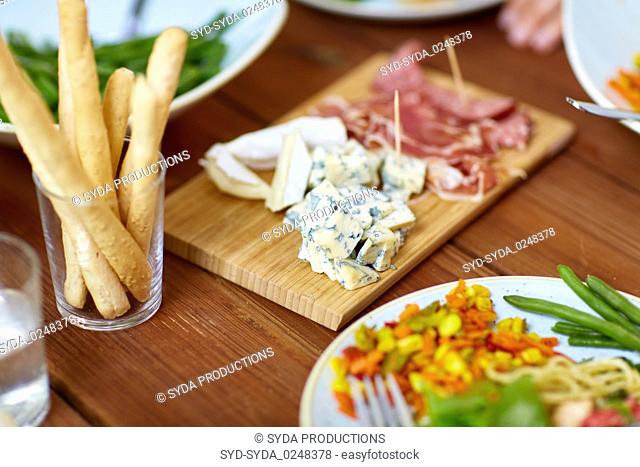 blue cheese and breadsticks on table