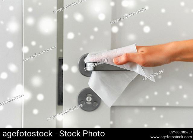 hand cleaning door handle with antiseptic wet wipe