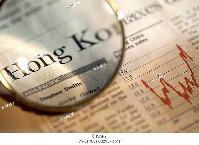 Magnifying glass enlarging stock market news