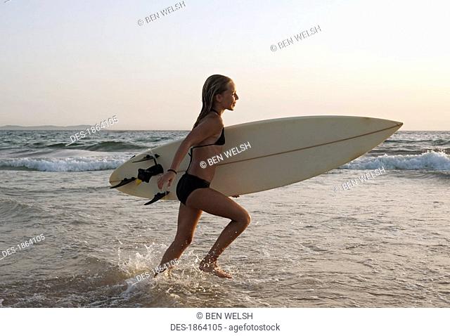 Young girl with surfboard