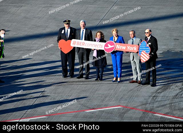 28 March 2022, Brandenburg, Schönefeld: At the capital's BER airport, standing in front of a United Airlines passenger plane before its maiden flight from BER...