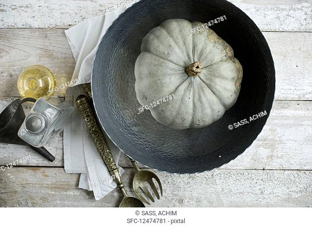 A Crown Prince pumpkin in a metal bowl