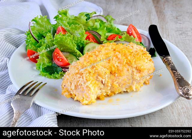 Baked to a golden, crispy crust chicken roll in breadcrumbs with parmesan and garnish of vegetables
