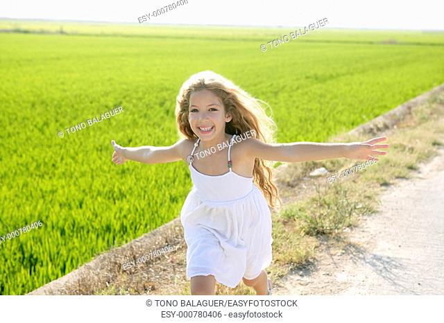 running open arms little happy girl green meadow field track