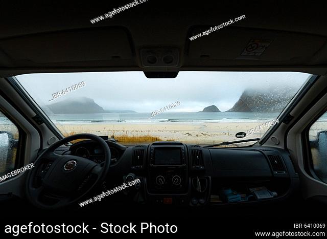 View from the windshield of the campervan on beach with turquoise water, Haukland beach, Lofoten, Norway, Europe