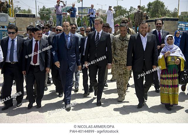 German Foreign Minister Guido Westerwelle (FDP, C) and Afghan General Atta Mohammed Noor (3rd L) walk on their way to the Blue Mosque in Masar-i-Scharif