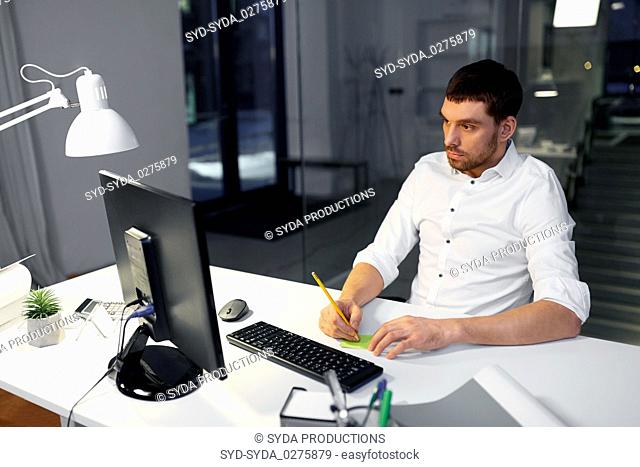 businessman with computer working at night office