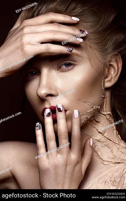 Beautiful girl with creative make-up art and design manicure. The beauty of the face. Photos shot in the studio
