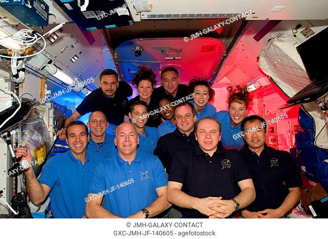 STS-131 and Expedition 23 crew members gather for a group portrait in the Kibo laboratory of the International Space Station while space shuttle Discovery...