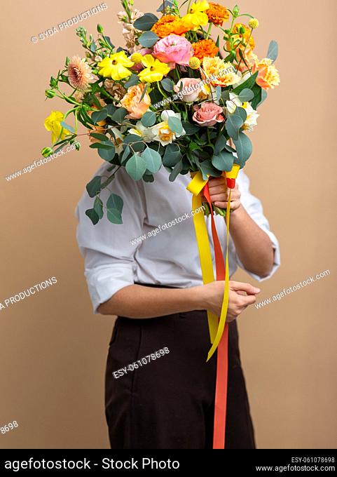 portrait of woman with bunch of flowers