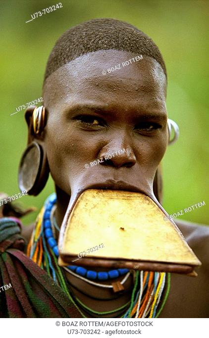 Portrait of a Surma woman wearing a wooden disc plate in her lower lip, Ethiopia