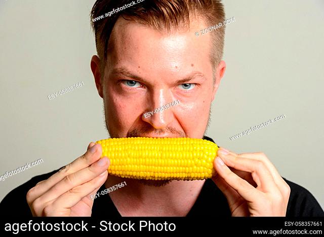 Studio shot of young handsome Scandinavian man against white background