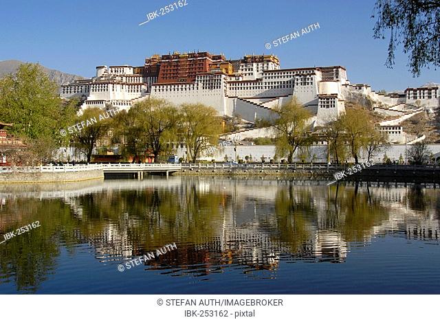 Potala winter palace of the Dalai Lama mirrors in a lake Lhasa Tibet China