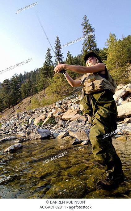 Young female fly fishing the Similkameen River near Princeton, British Columbia, Canada