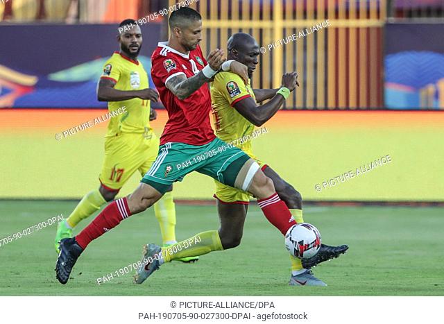 05 July 2019, Egypt, Cairo: Morocco's Manuel da Costa (C) and Benin's Mickael Pote battle for the ball during the 2019 Africa Cup of Nations round of 16 soccer...