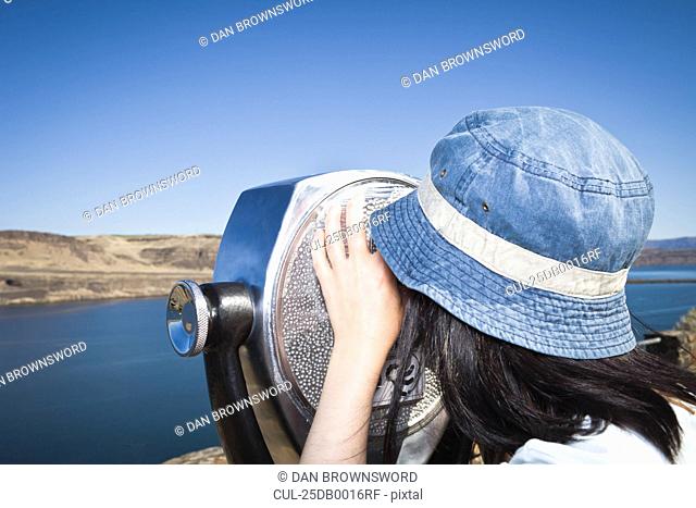 Woman using telescopic viewer