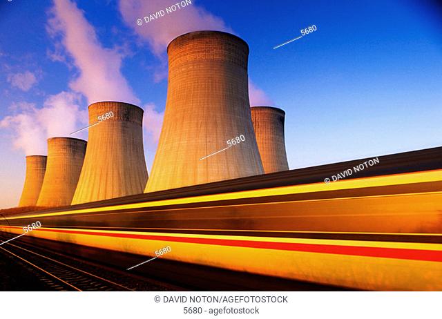 Train at speed. Coal-fired power station. Nottinghamshire. England
