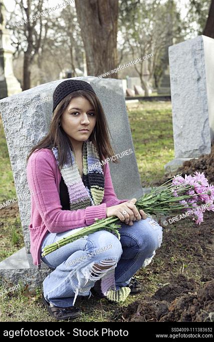Young Hispanic woman at grave
