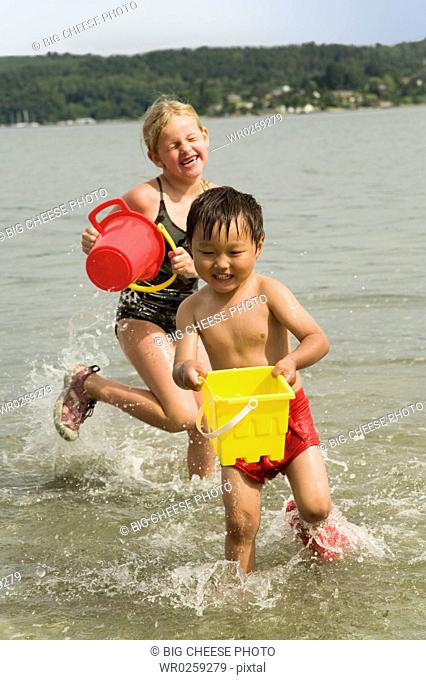 Boy and girl playing in water