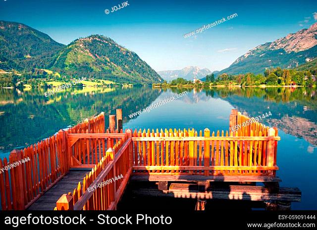 Bright sunny view of small boat pier in Gessl village. Colorful summer morning on the Grundlsee lake, Liezen District of Styria, Austria, Alps. Europe