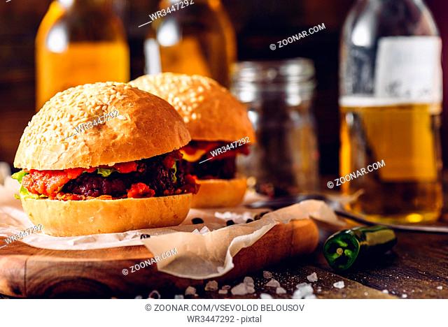 Two Homemade Burger with Some Ingredients and Few Bottle of Beer