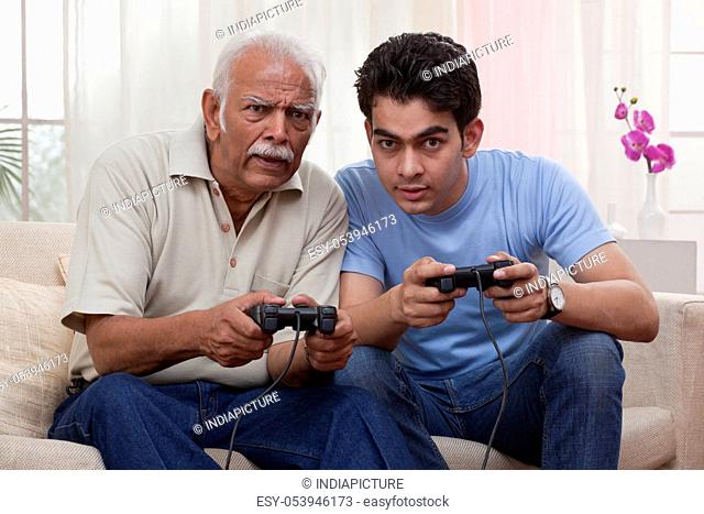 Grandfather and grandson playing video game