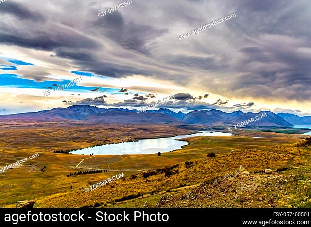 Travel to a faraway country. New Zealand, South Island. Lake Tekapo on cloudy day. The lake in the mountains. The concept of active, exotic and photo tourism