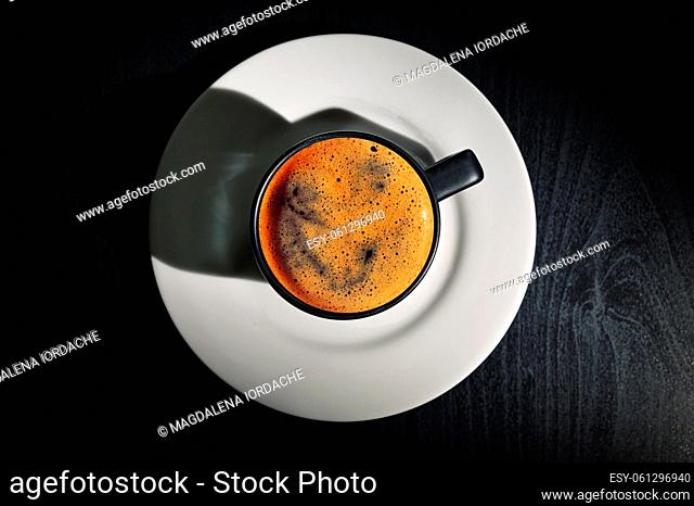 Black espresso cup and Shadow on black table