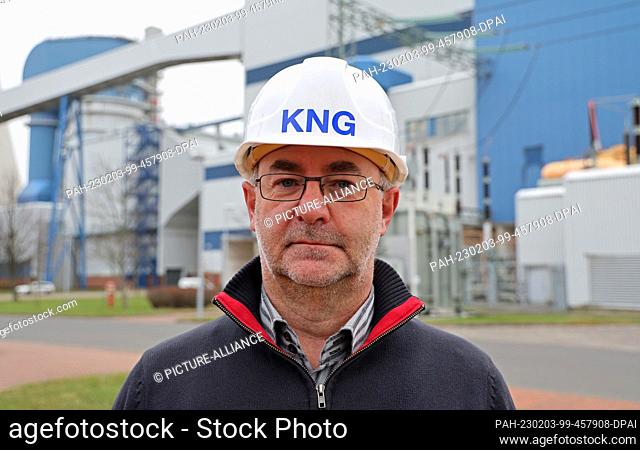PRODUCTION - 02 February 2023, Mecklenburg-Western Pomerania, Rostock: Axel Becker, power plant manager, stands in front of the coal-fired power plant in the...