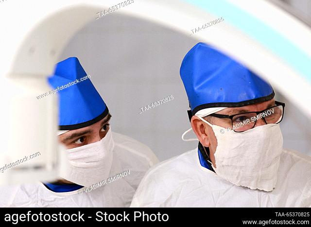 RUSSIA, IVANOVO - NOVEMBER 30, 2023: Doctors Alexei Orekhov (L) and Pavel Solomatnikov perform a lithotripsy using thulium fibre laser at the urology department...