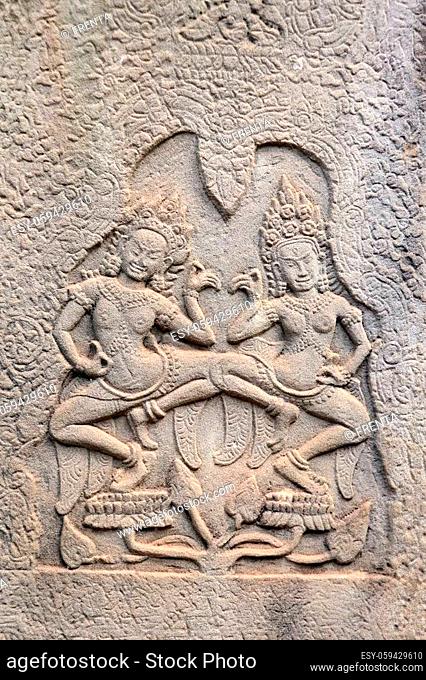 Wall carving with two womans - dancers apsara, Prasat Bayon Temple, famous Angkor Wat complex, khmer culture, Siem Reap, Cambodia