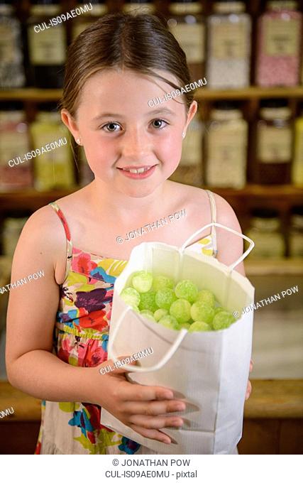 Girl holding bag of confectionery