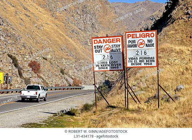 Killer Kern River sign showing death count in Spanish and English in California at mouth of canyon