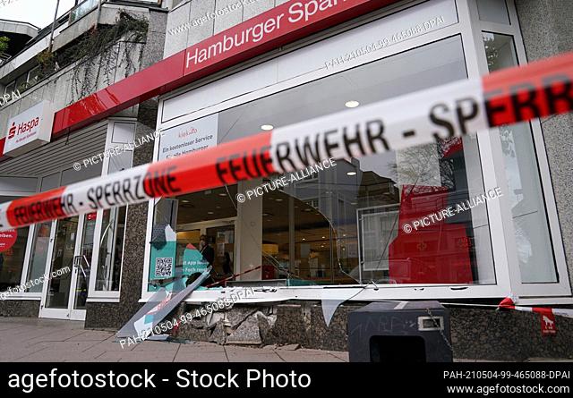 04 May 2021, Hamburg: Shards of glass and stones of the destroyed shop window frame lie in front of and inside a Haspa branch after an accident