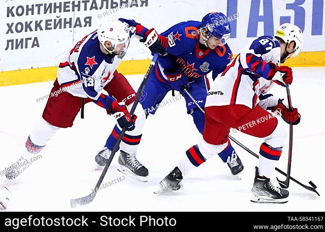 RUSSIA, ST PETERSBURG - APRIL 10, 2023: SKA St Petersburg’s Nikolai Polyakov (C), CSKA Moscow’s Artyom Sergeyev (L) and Andrei Svetlakov fight for the puck in...