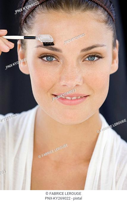 Portrait of a woman applying eye make-up
