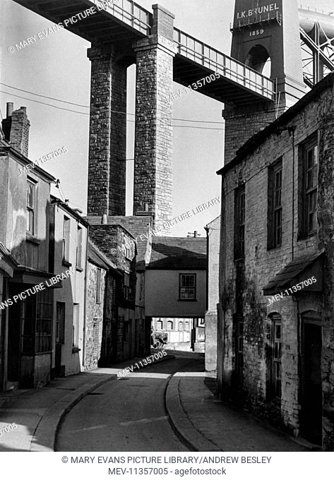 Street scene in Saltash, Cornwall, with Brunel's Royal Albert Bridge towering above, crossing the River Tamar between Plymouth, Devon, and Saltash, Cornwall
