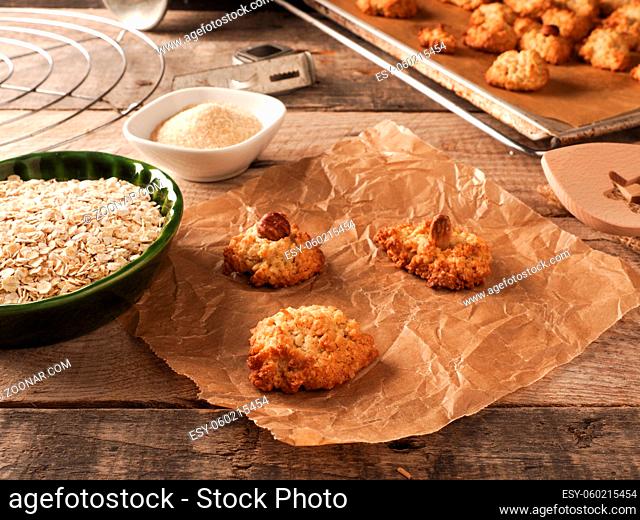 Oatmeal cookies on baking paper with organic baking ingredients, healthy food concept