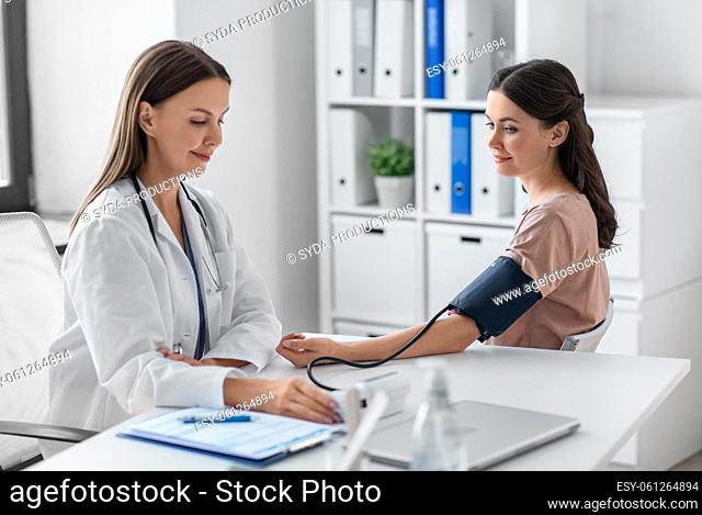 female doctor with tonometer and patient at clinic