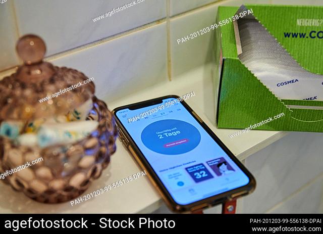 ILLUSTRATION - 27 November 2020, Berlin: Tampons, panty liners and a smartphone with a menstrual app are in the bathroom. Photo: Annette Riedl/dpa