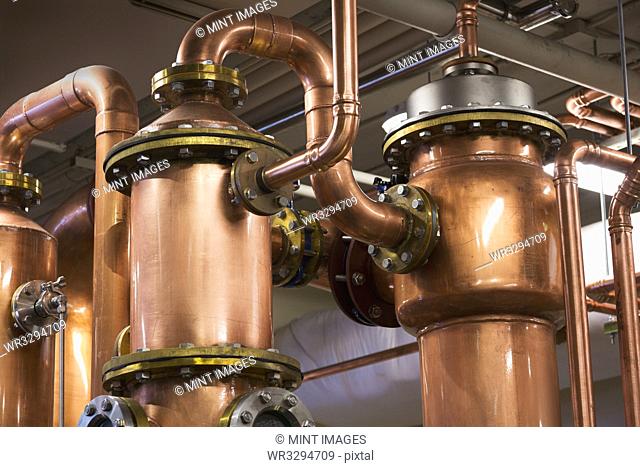 Close up of copper stills in distillery